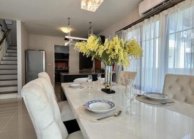 Modern dining room with elegant chandelier and table setting