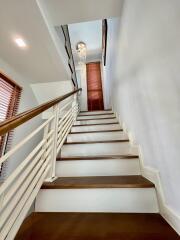 Modern staircase with wooden steps and a handrail