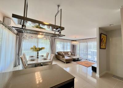 Open-plan living and dining area with modern furnishings and large windows