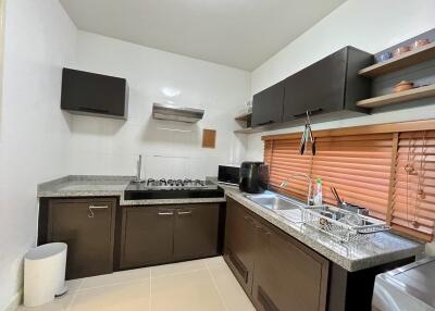 Modern kitchen with appliances and dark cabinets