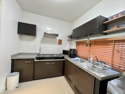 Modern kitchen with appliances and dark cabinets