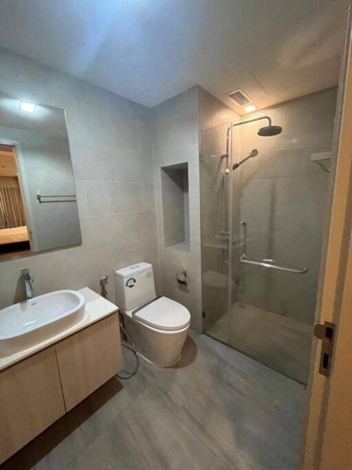 Modern bathroom with sink, toilet, and glass-enclosed shower
