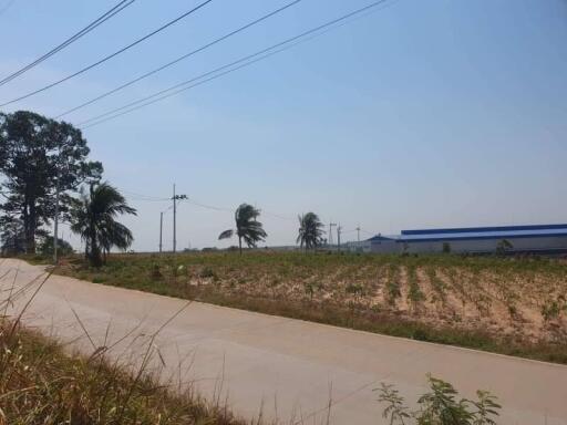 Exterior view showing a road, field, and distant buildings