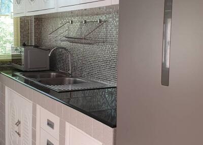 Modern kitchen with stainless steel appliances and tiled backsplash
