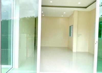 Bright empty room with large windows and glossy tiled floors