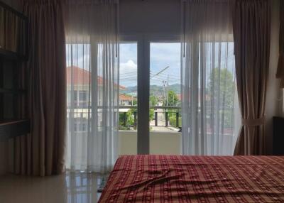 Bedroom with large window and balcony