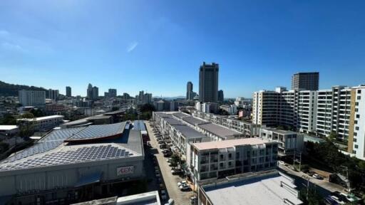 Aerial view of an urban area with multiple buildings and a clear blue sky.