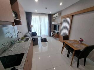 Modern main living space with kitchen, sitting area, and dining table