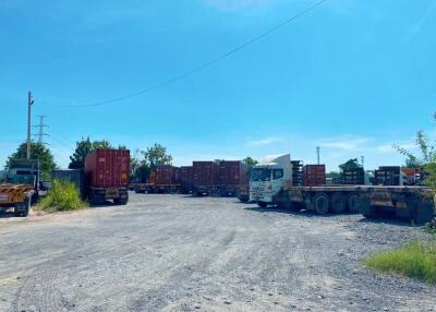 Spacious outdoor area with trucks and containers