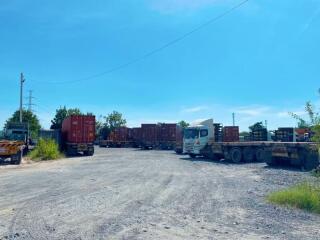 Spacious outdoor area with trucks and containers