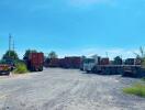 Spacious outdoor area with trucks and containers