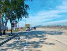 A road with vehicles and a clear blue sky