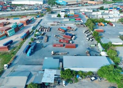 Aerial view of an industrial area with shipping containers and trucks