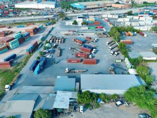 Aerial view of an industrial area with shipping containers and trucks