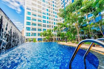 Modern residential building with swimming pool and water feature