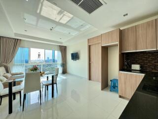 Modern living room and kitchen with city view