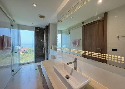 Spacious modern bathroom with large mirror and scenic view