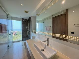 Spacious modern bathroom with large mirror and scenic view