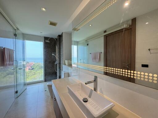 Spacious modern bathroom with large mirror and scenic view