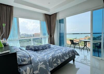 Bright bedroom with large windows and a sea view