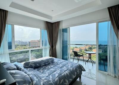 Bedroom with large windows and ocean view