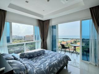 Bedroom with large windows and ocean view