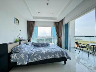 Modern bedroom with large windows and a balcony