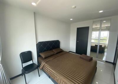 Bedroom with a bed, chair, and mirrored closet