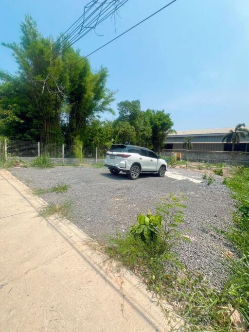 Open parking area with a white car