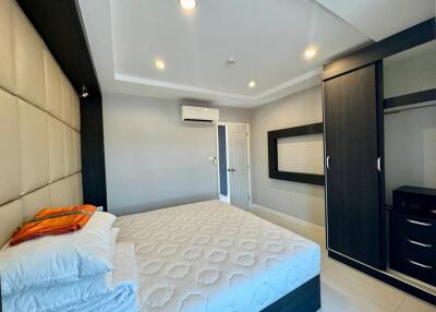 Modern bedroom with bed, wardrobe, and air conditioning