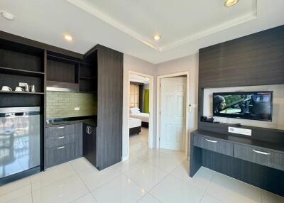 Modern kitchen and living area with view into the bedroom