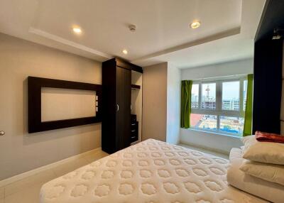 Spacious bedroom with large window and modern furniture