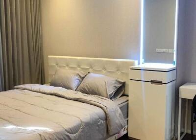 Spacious bedroom with double bed and modern furniture