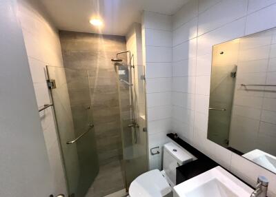 Modern bathroom with a glass shower enclosure and tiled walls