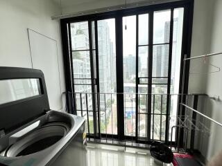 Laundry room with washer and large windows