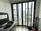 Laundry room with washer and large windows