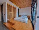 Modern bedroom with wooden ceiling and raised platform bed