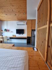 Cozy bedroom with wooden accents and modern amenities