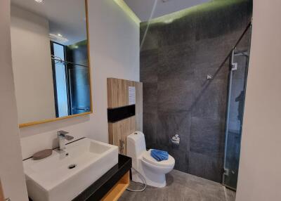 Modern bathroom with sink, toilet, and shower