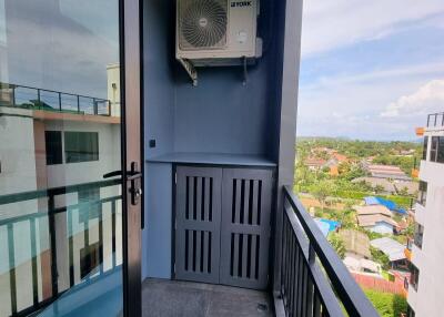 Modern balcony with outdoor AC unit and glass door