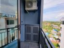 Modern balcony with outdoor AC unit and glass door