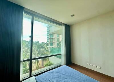 Modern bedroom with large window and a view