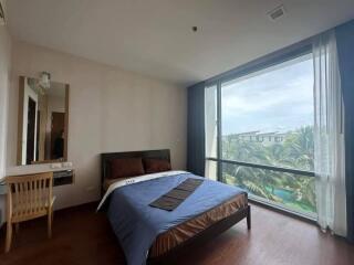 Spacious bedroom with large window and scenic view