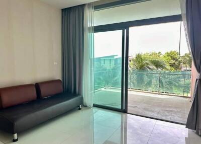 Living room with balcony area and large glass sliding doors