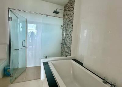 Modern bathroom with bathtub and glass shower enclosure