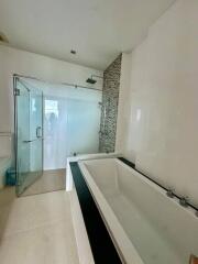 Modern bathroom with bathtub and glass shower enclosure