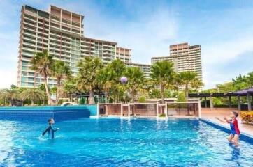 Outdoor swimming pool with apartment buildings in the background