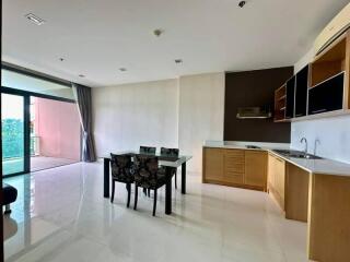 Modern open-plan kitchen and dining area with a view of a balcony