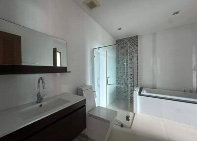 Modern bathroom with a sink, toilet, shower, and bathtub