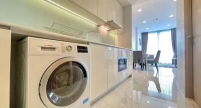 Modern kitchen with washing machine and dining area